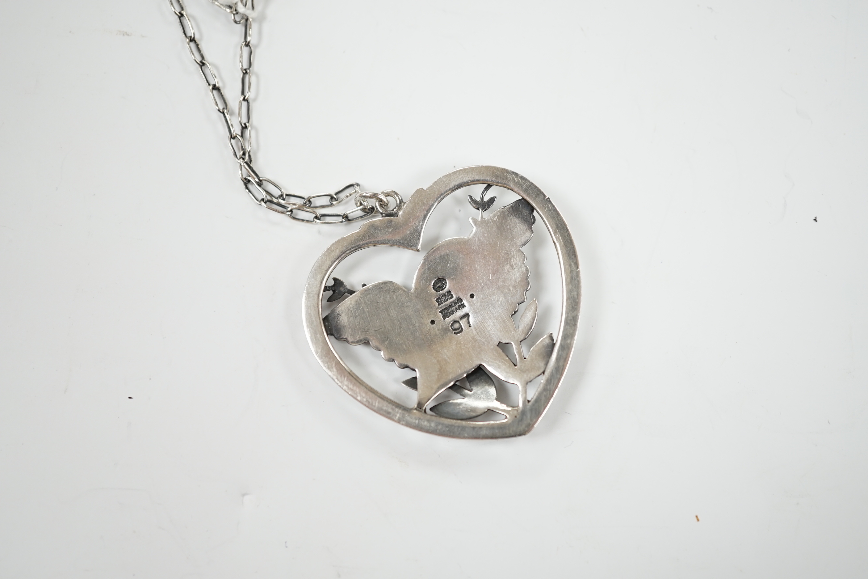 A Georg Jensen sterling heart shaped 'Robin with frond' pendant, on chain, design no. 97, width 39mm.